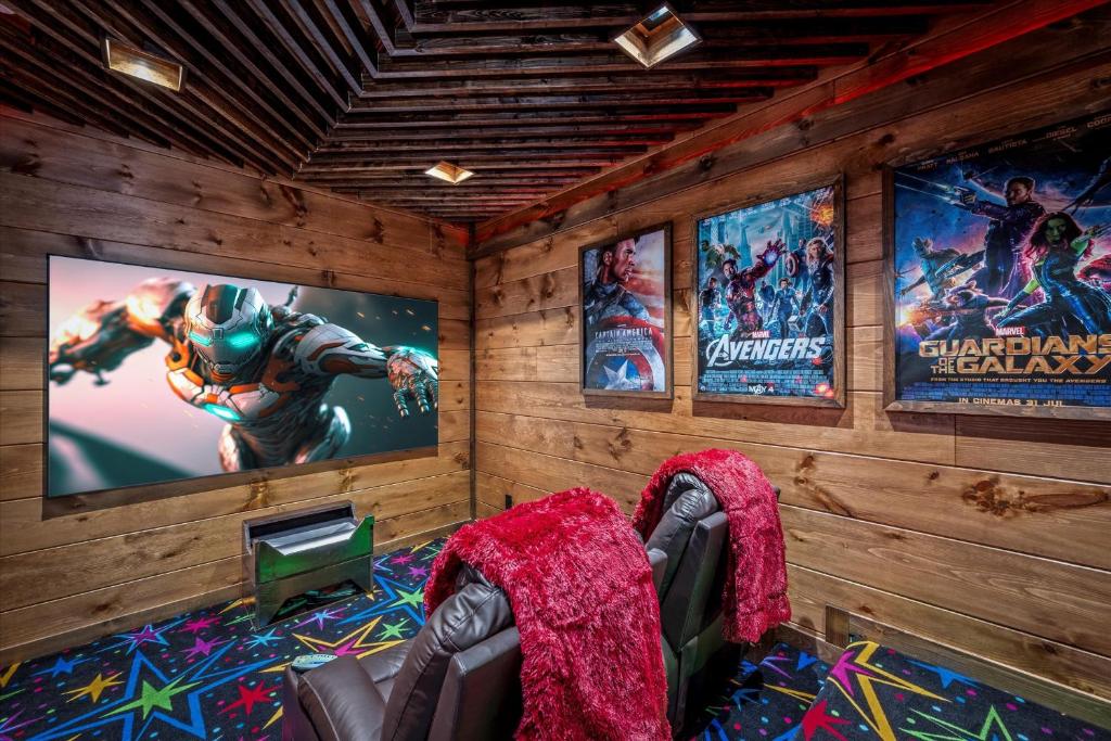 Recliners facing the big screen in the movie room · © Alpine Haven