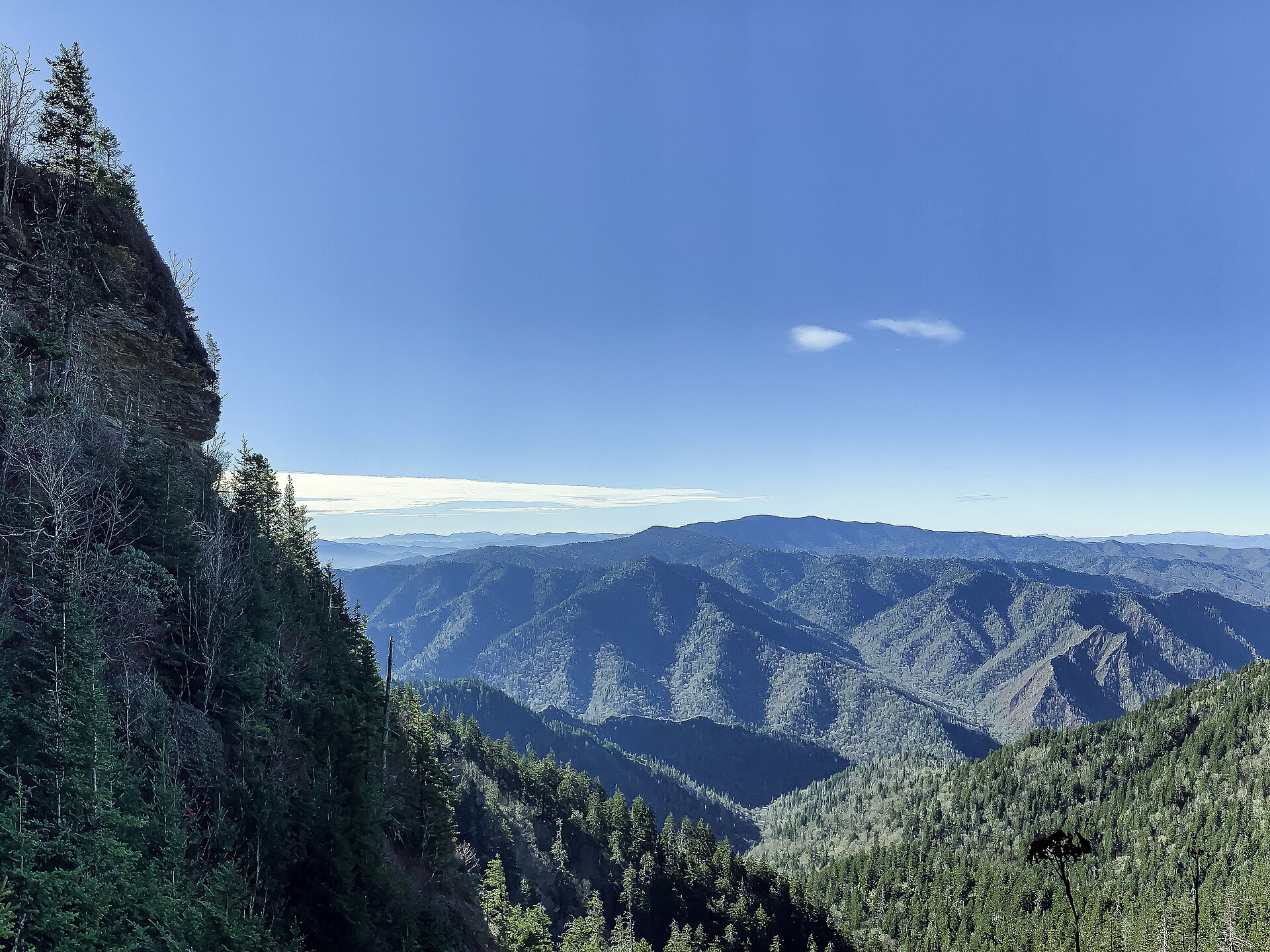 An open viewpoint on the upper Alum Cave Trail, with Clingmans Dome behind