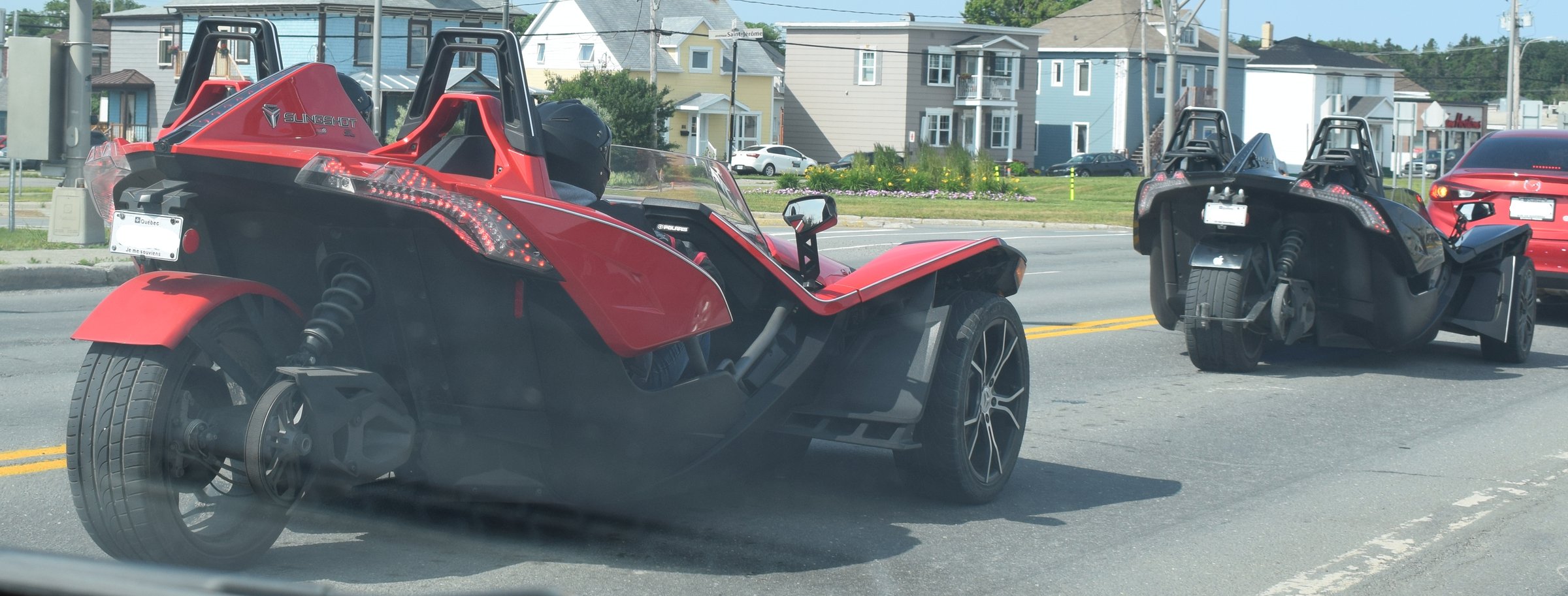 Polaris Slingshots on the road in Matane, Quebec: two seats, three wheels
