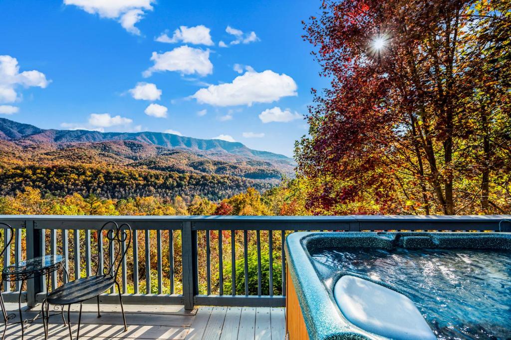 The hot tub at the deck rail, facing the autumn ridges · © Barenberg Cabin