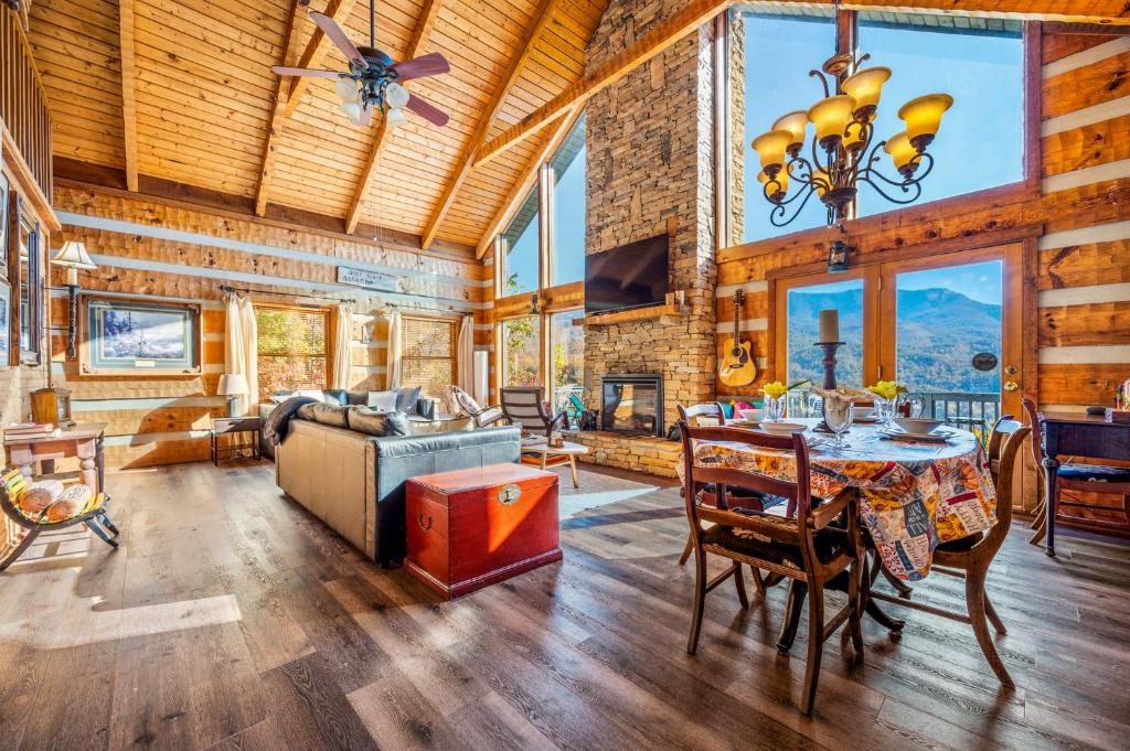 The great room under a timber ceiling, with the stone fireplace · © Barenberg Cabin