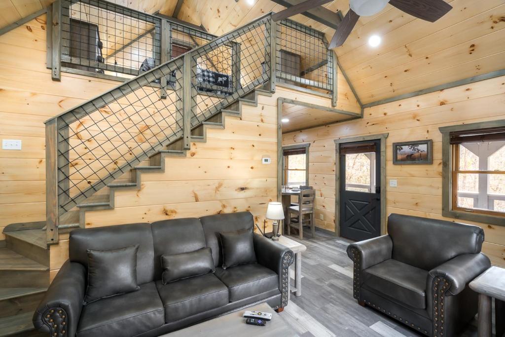 Leather seating below the staircase up to the loft · © Bear Necessity