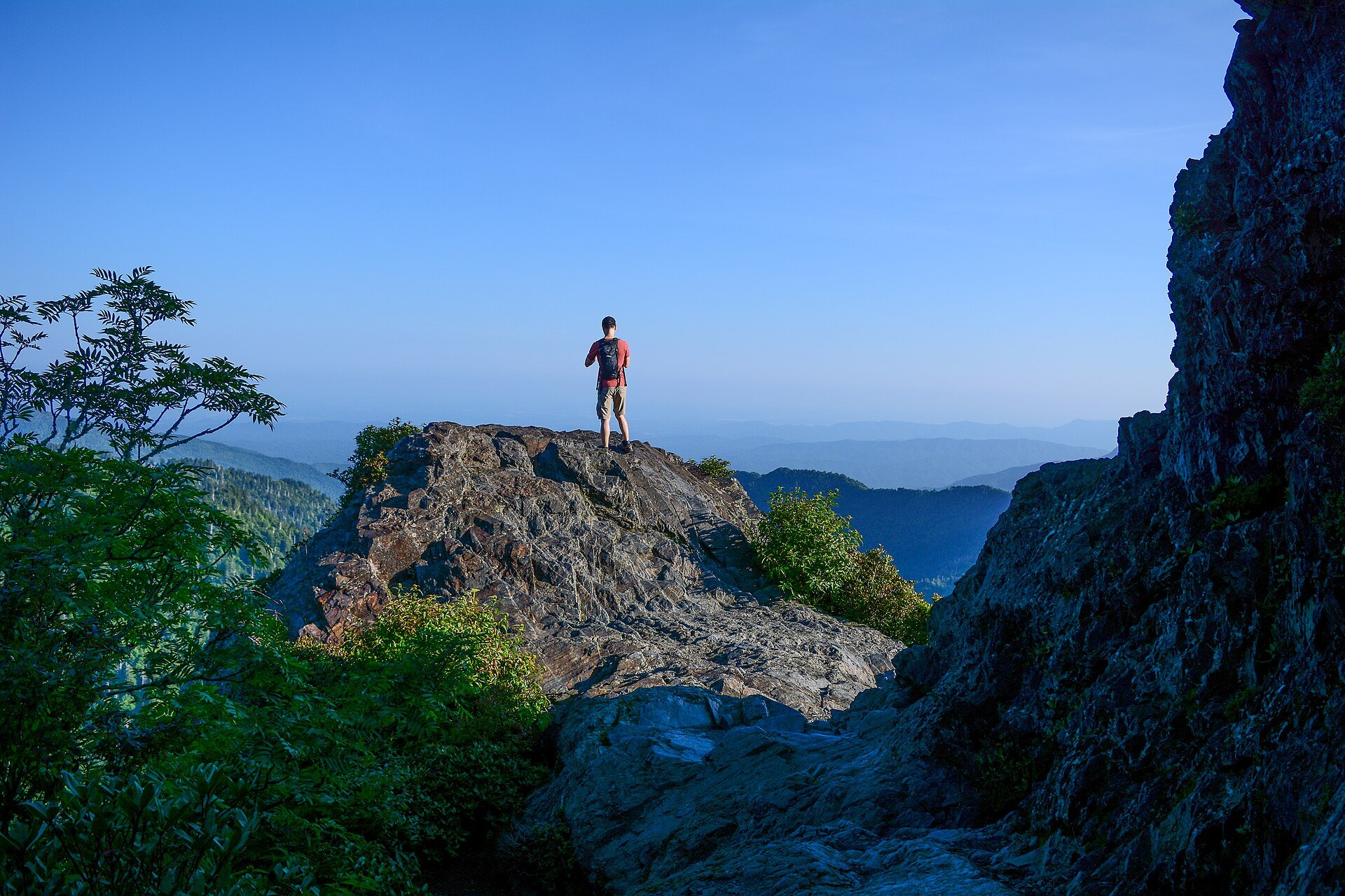A hiker on the bare rock of Charlies Bunion on a clear summer day