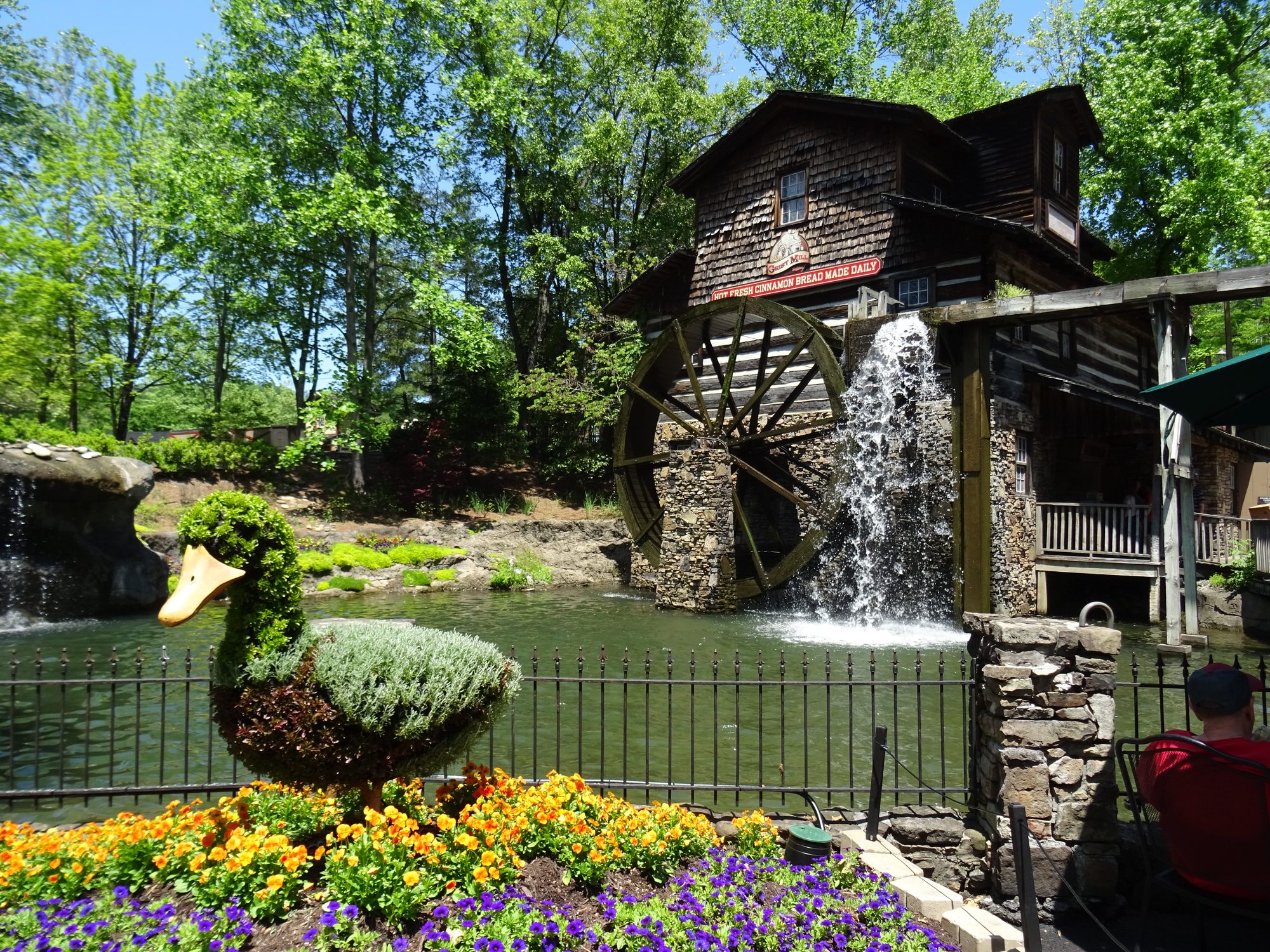 A waterwheel mill and a duck topiary by the pond at Dollywood