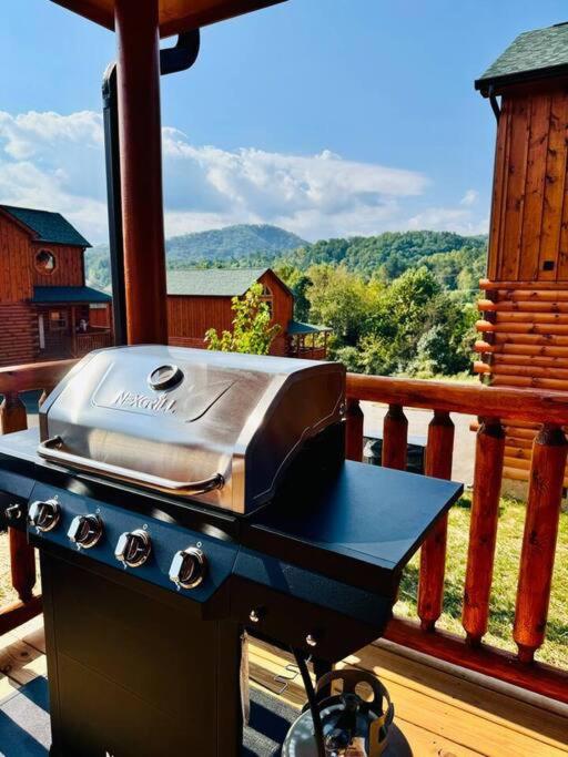 The covered-deck grill, looking out to the wooded hills · © Enchanted Peak Lodge