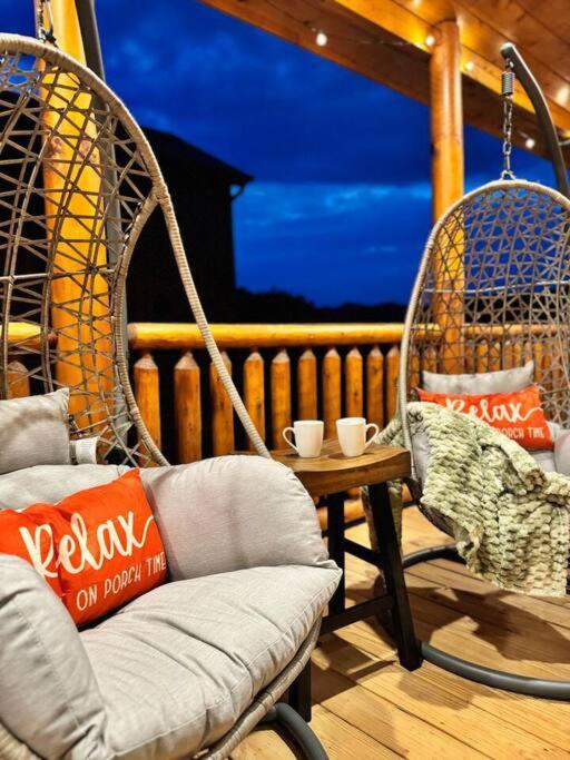 Hanging egg chairs on the porch as the evening comes in · © Enchanted Peak Lodge
