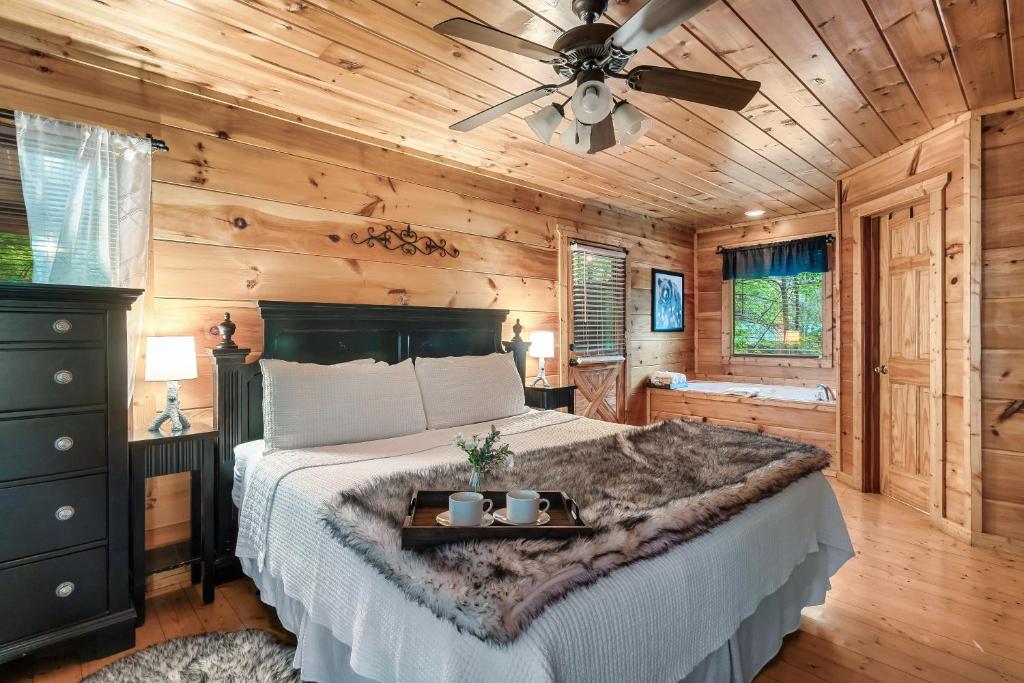 The bedroom, with a soaking tub set in the corner · © Ever & After Cabin