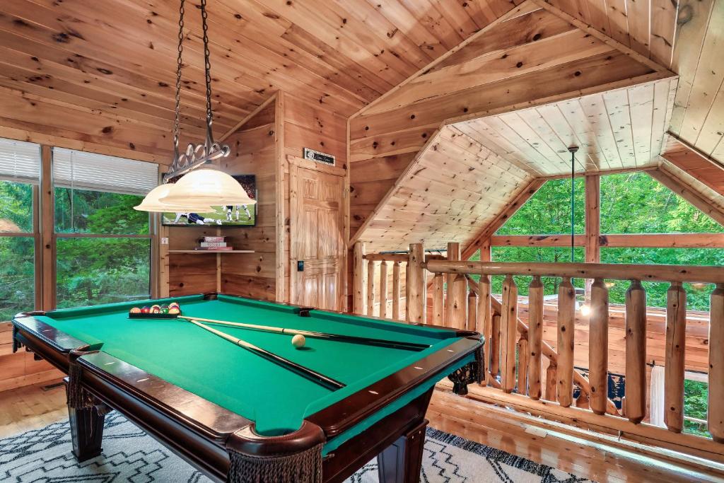 The pool table in the open loft above the living room · © Ever & After Cabin