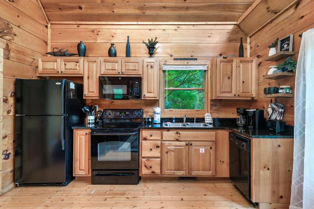 The pine kitchen, with a window onto the trees · © Ever & After Cabin