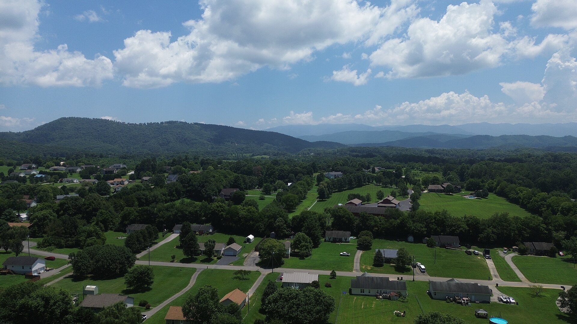 Homes, fields and wooded ridges in rural Sevier County, not the park itself