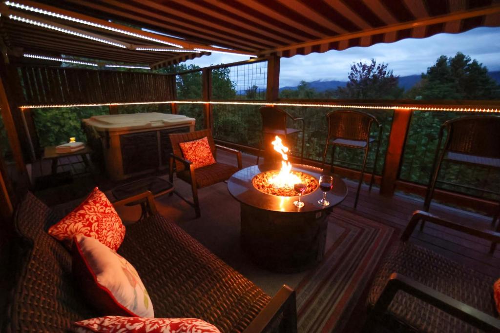The lit fire pit on the deck at dusk above the valley · © Glimpse of Bearadise