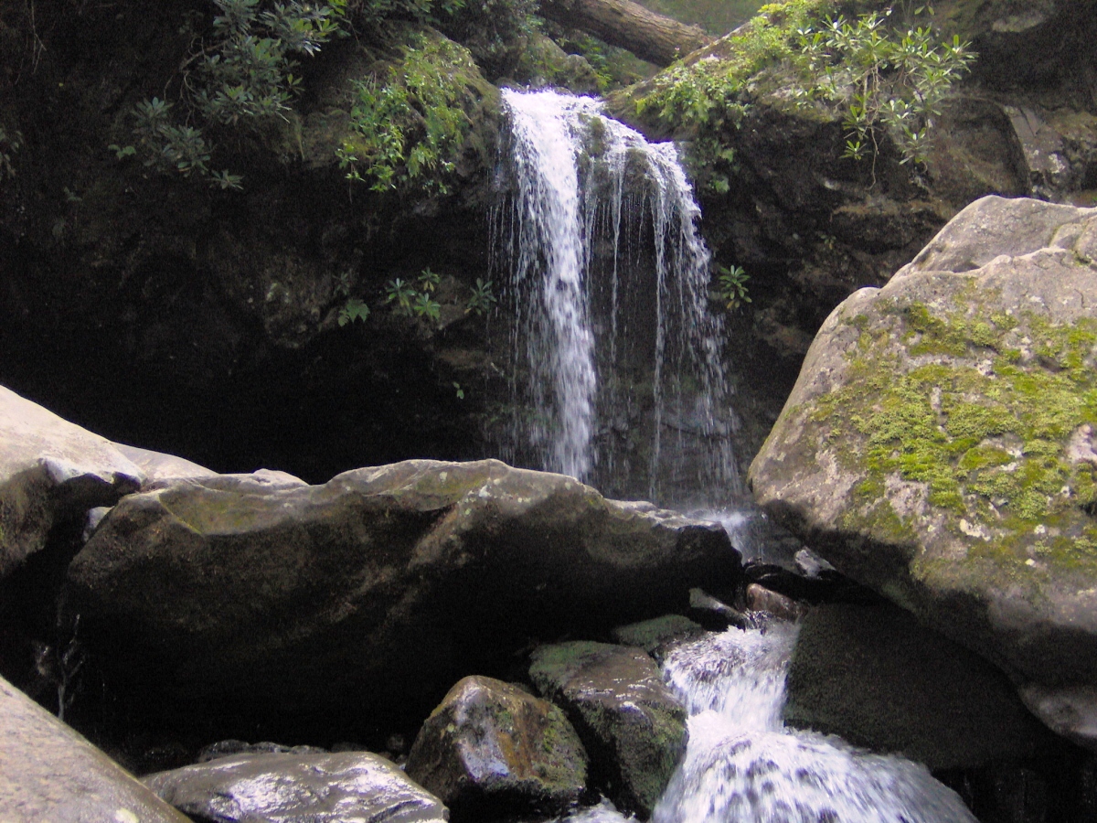 Grotto Falls dropping over the rock ledge the trail passes behind