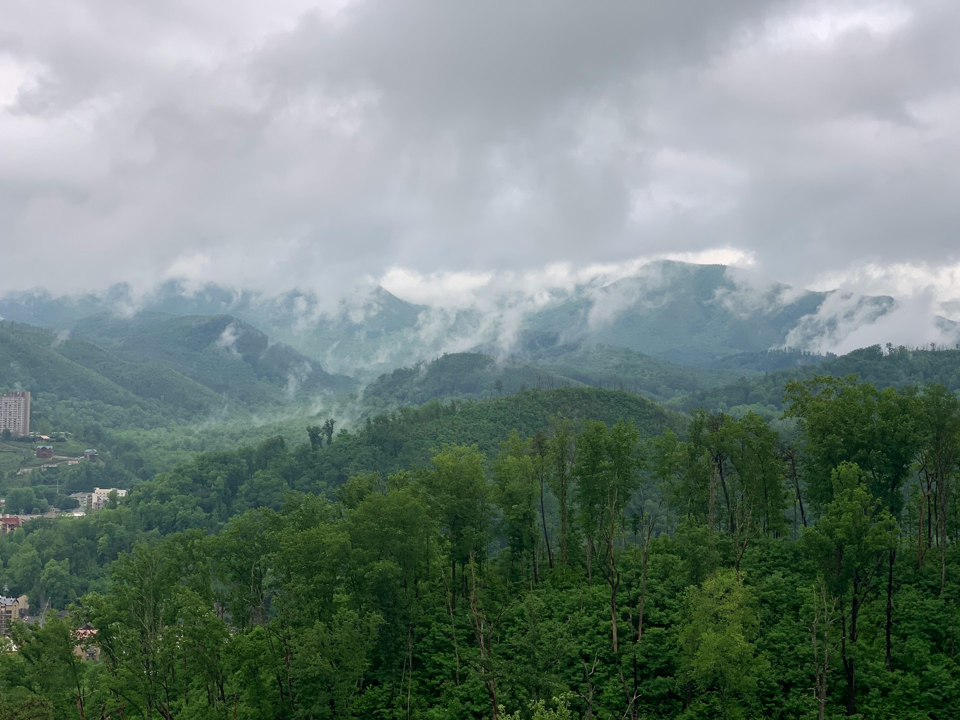 Cloud lifting off the ridges above Gatlinburg, a town high-rise at left