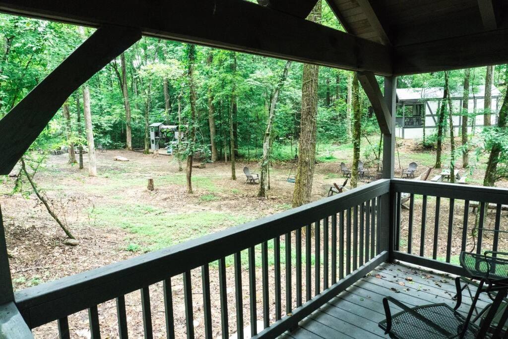 The covered back deck overlooking the wooded common area · © The Helena Tiny Home
