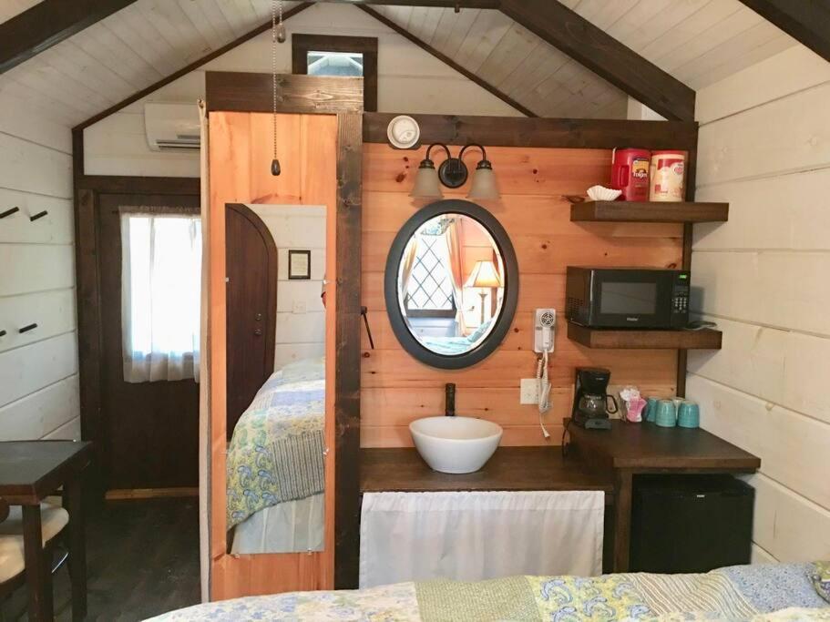 The kitchenette corner with microwave, coffee maker and vessel sink · © The Helena Tiny Home