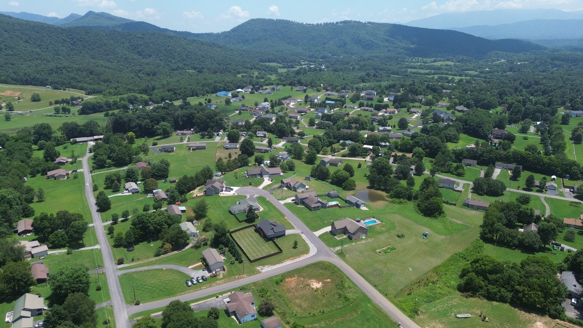 Homes, pastures and wooded ridges in rural Sevier County, seen from above