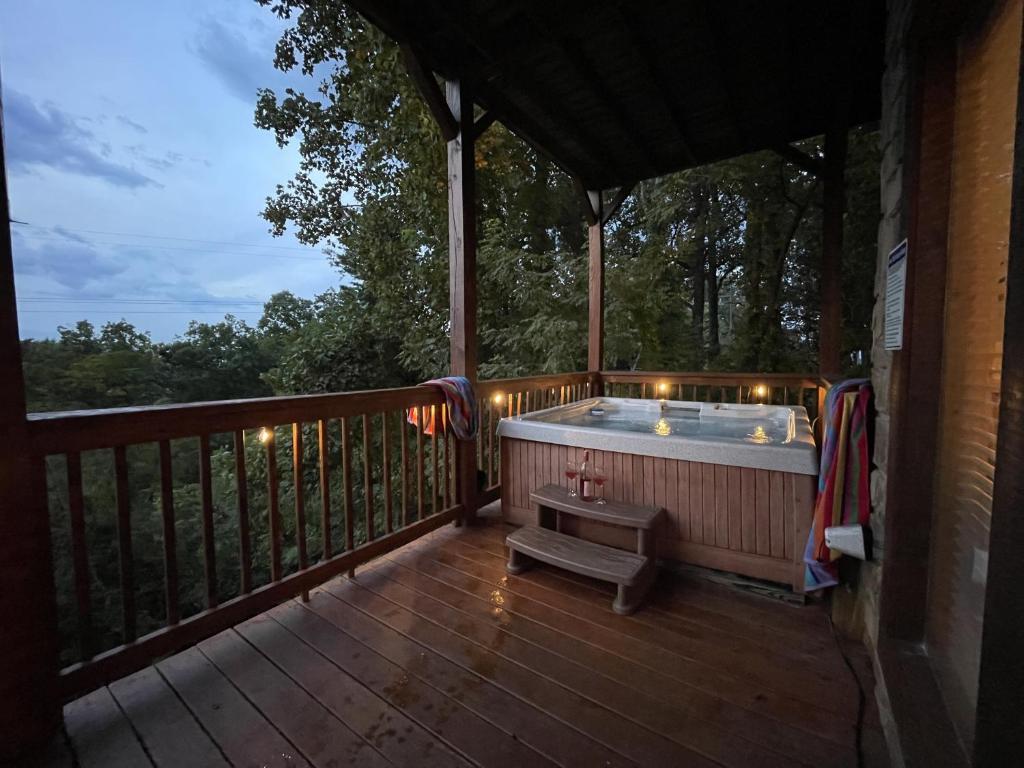 The hot tub under the covered deck at dusk · © Honey Bear