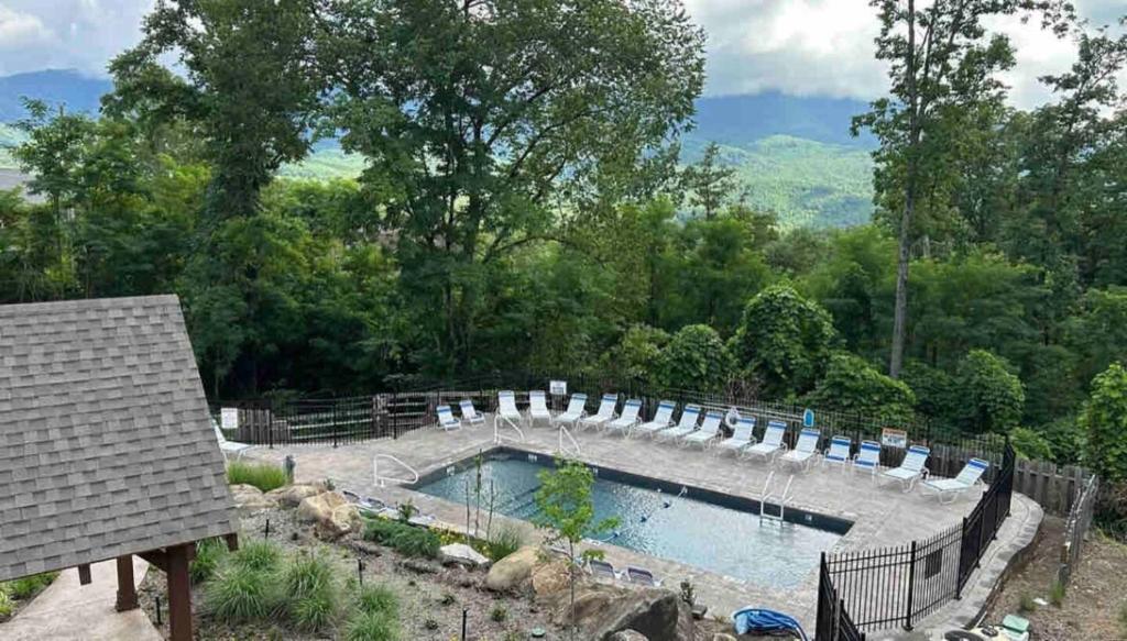 The resort's seasonal outdoor pool, framed by the surrounding ridgelines · © Lux Cabin Mtn Views