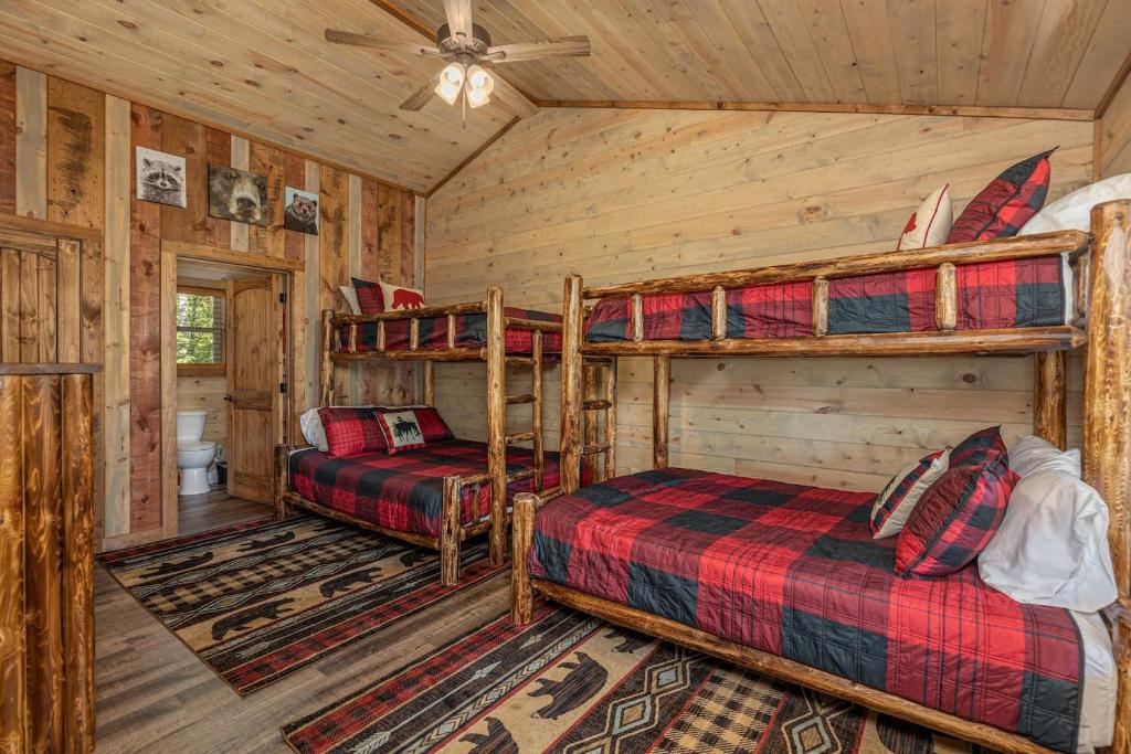 A bunk-bed room in plaid, built for the kids in the group · © Lux Cabin Mtn Views