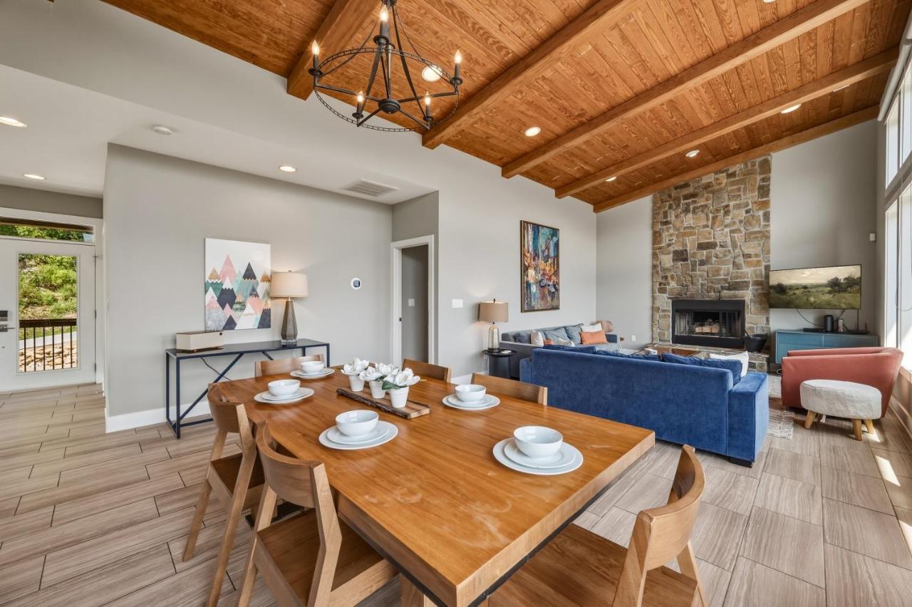 The stone fireplace anchoring the open living area · © The Modern Cabin on Beanstalk Road