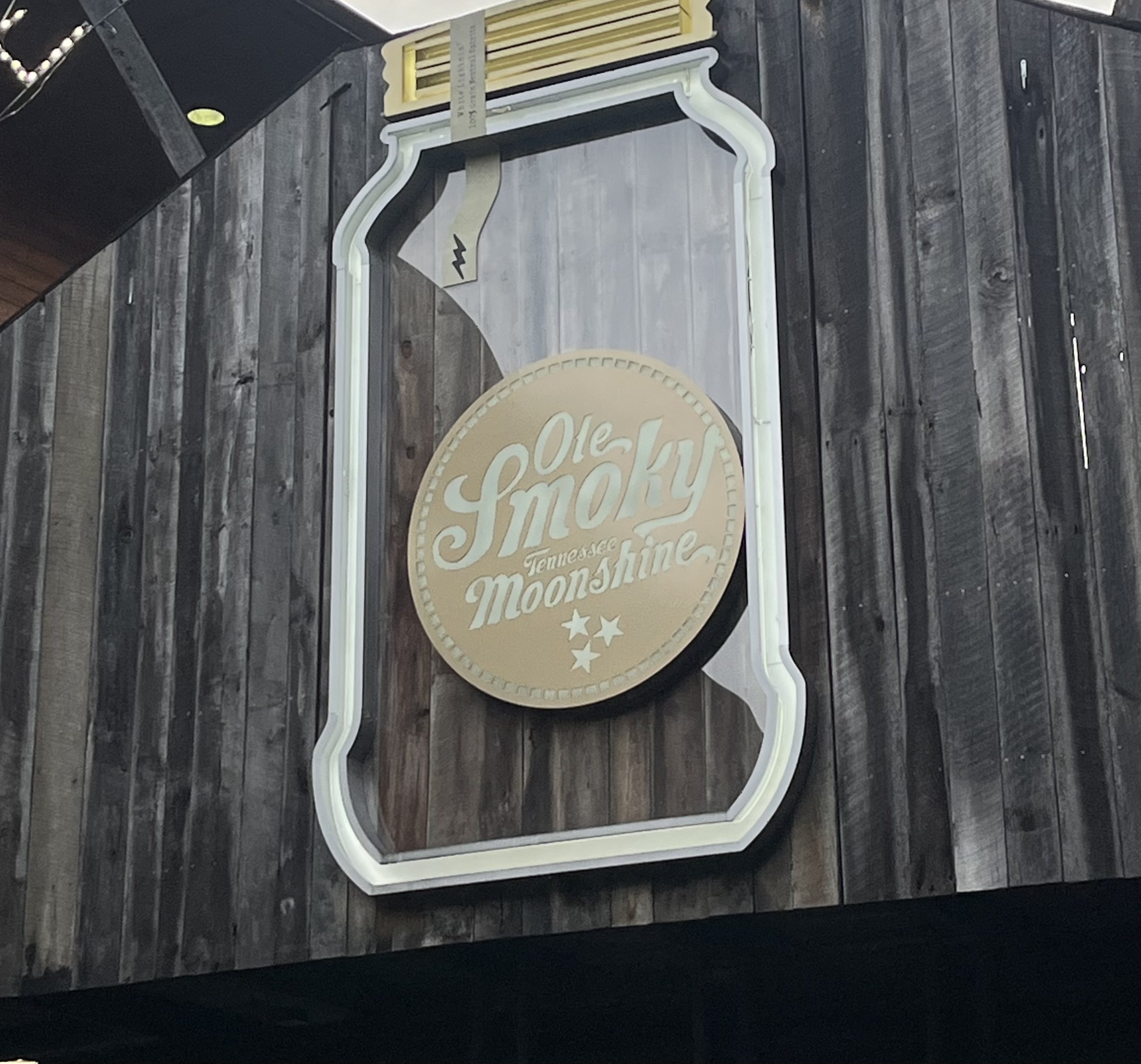 Ole Smoky's jar-shaped sign on a weathered-wood front in Gatlinburg