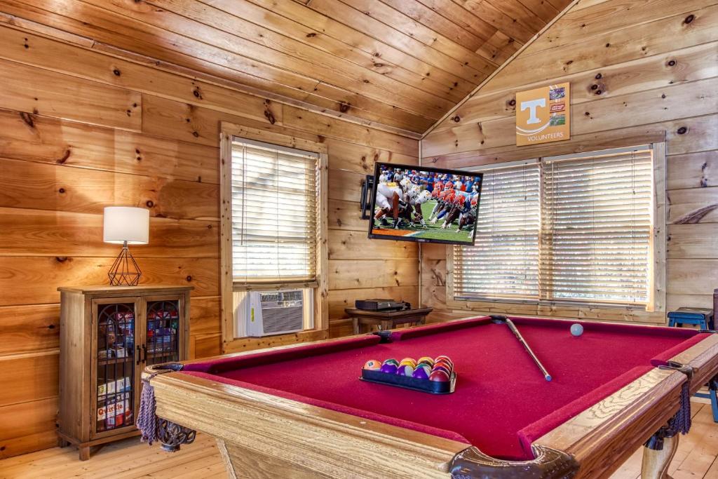 The pool table in the upstairs loft, with a cabinet full of games · © Morning Glory