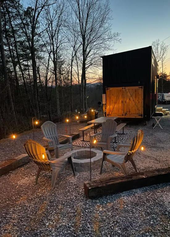 The fire pit and Adirondack chairs at dusk · © Mountain Top Tiny House