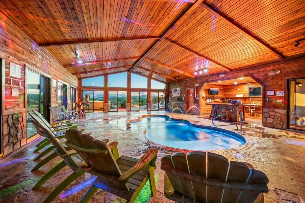 The indoor pool, with the mountains through the glass wall · © Mountain View Mansion