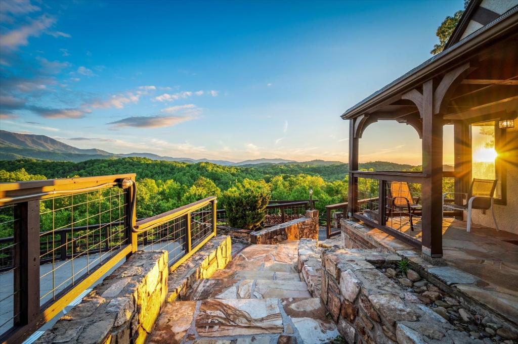 Stone steps down to the terrace at golden hour · © Mountain View Mansion
