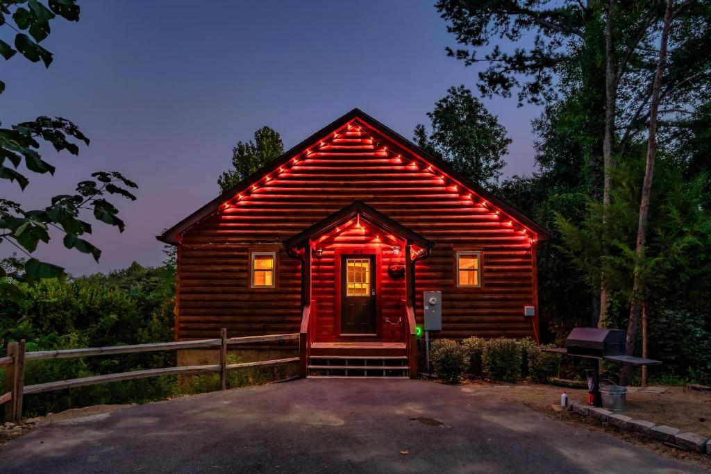 The front of the cabin lit up at dusk · © Mountains r Calling