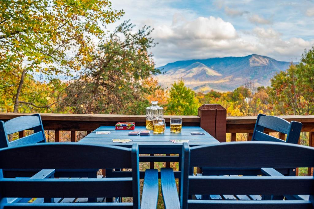 Cards and drinks on the deck table, the high ridges beyond · © The Sauna Cabin on South Baden