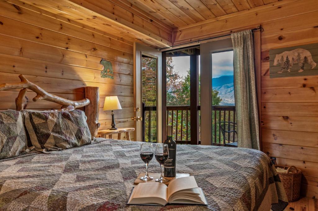 A bedroom with glass doors out to a balcony and the ridges · © The Sauna Cabin on South Baden