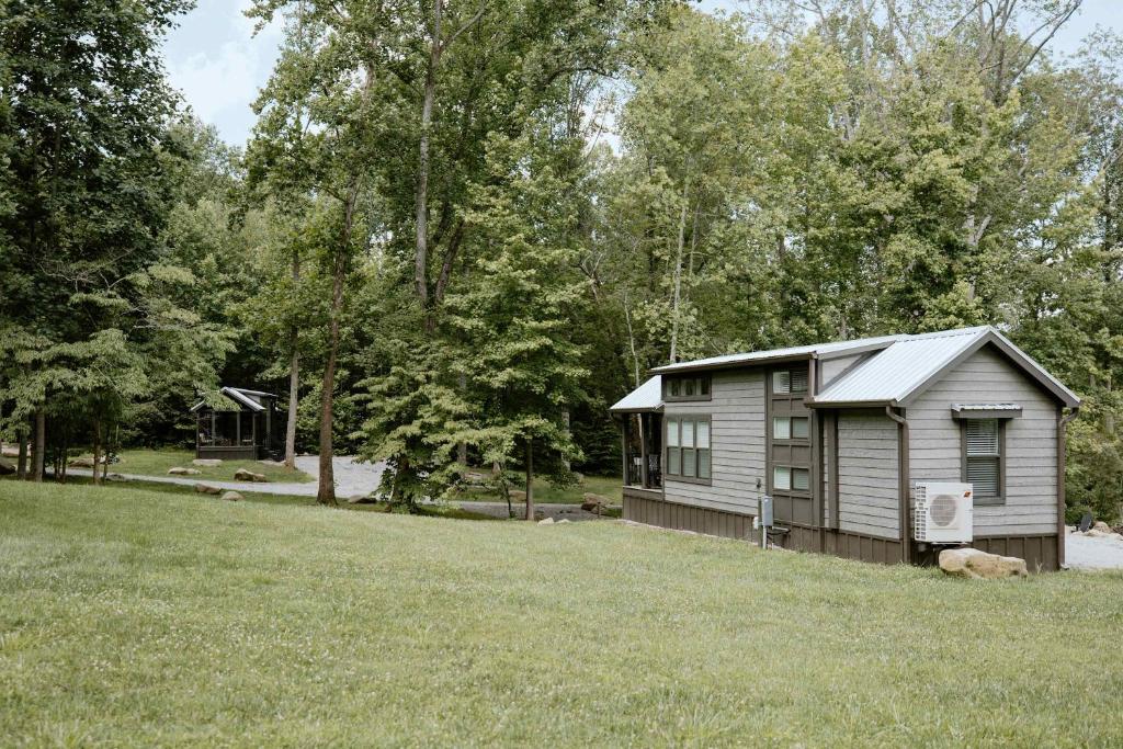 A tiny home on the lawn at the edge of the hardwoods · © Oak Cabin