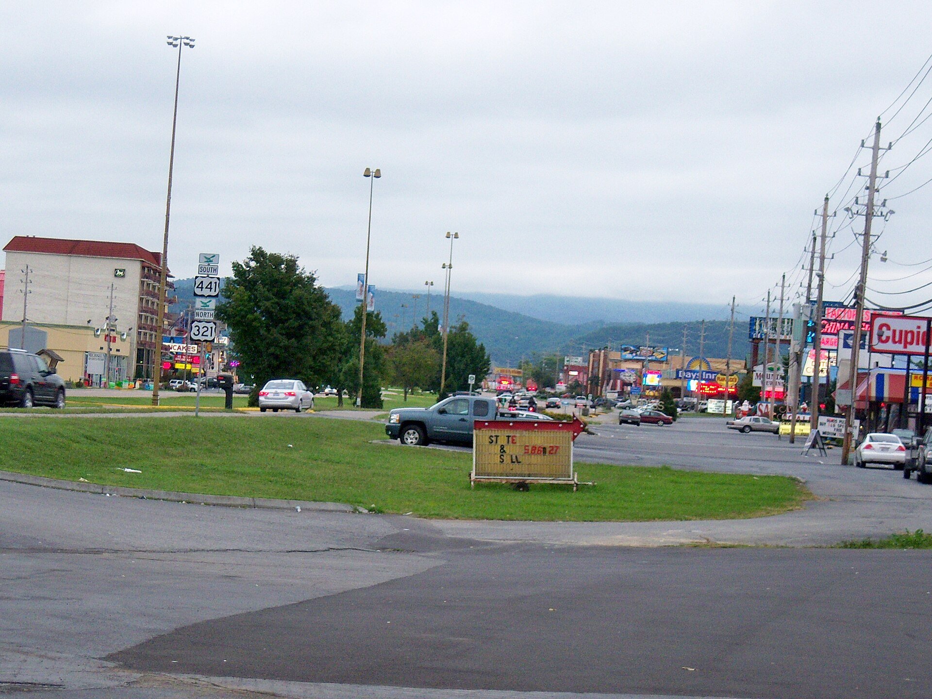 Signs, motels and billboards along the Parkway in Pigeon Forge, the town the tour pokes fun at
