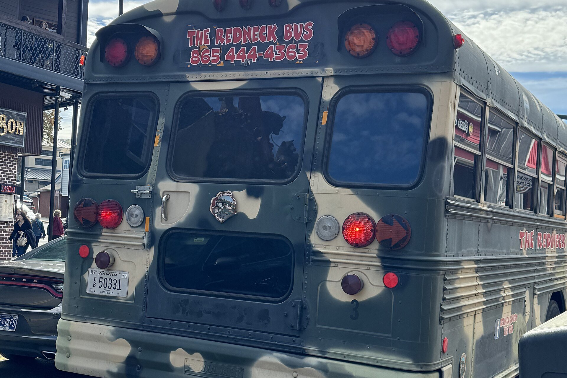 The camo Redneck Bus, a converted school bus, seen from behind in Gatlinburg