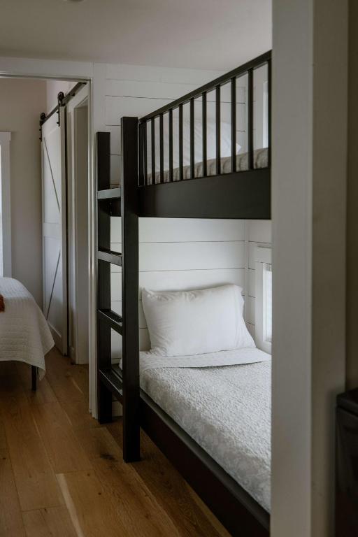 Bunk beds beside the barn door to the bedroom · © Sage Cabin