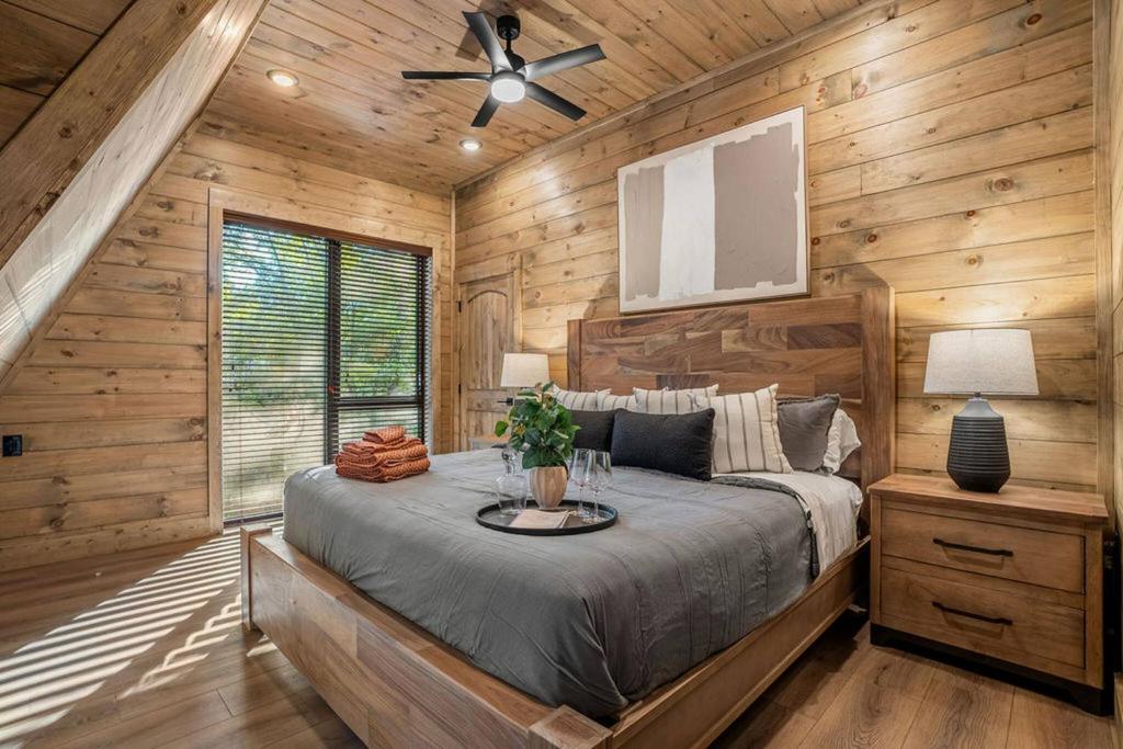 A king bedroom under the slope of the A-frame · © The Bold Covemont A-Frame