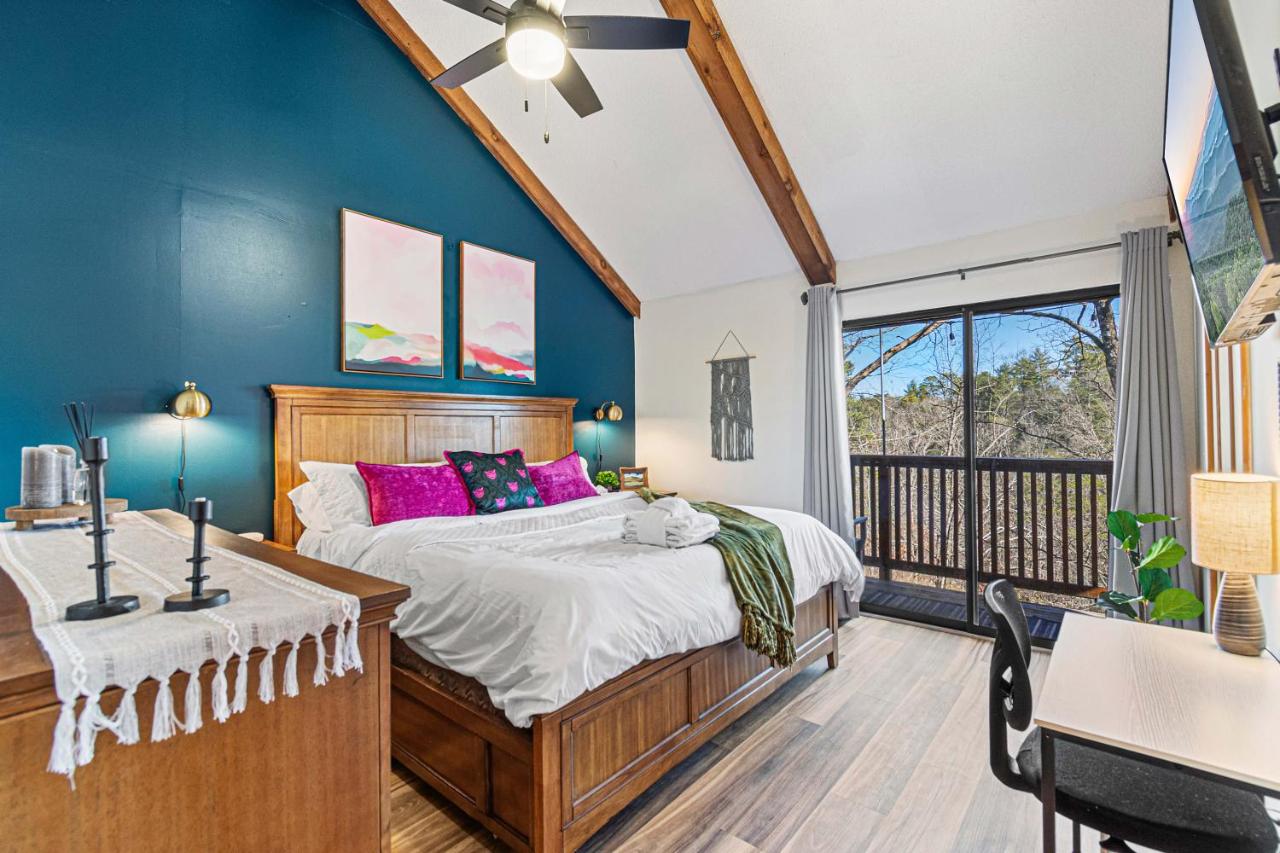 A king bedroom opening to a private balcony over the trees · © The Family Stone