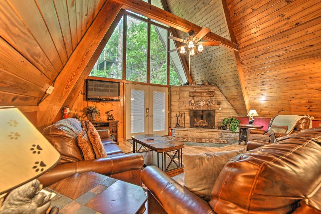 The living room under the glass gable, with its stone fireplace · © The Green-Roof A-Frame