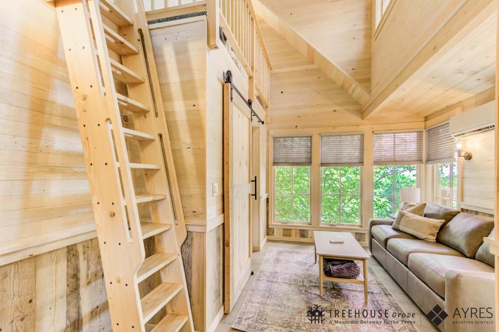 The living room and the ladder up to the loft · © The Mulberry at Treehouse Grove