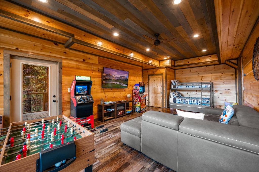 Arcade cabinets, foosball and a bunk bed in the game room · © The Overlook