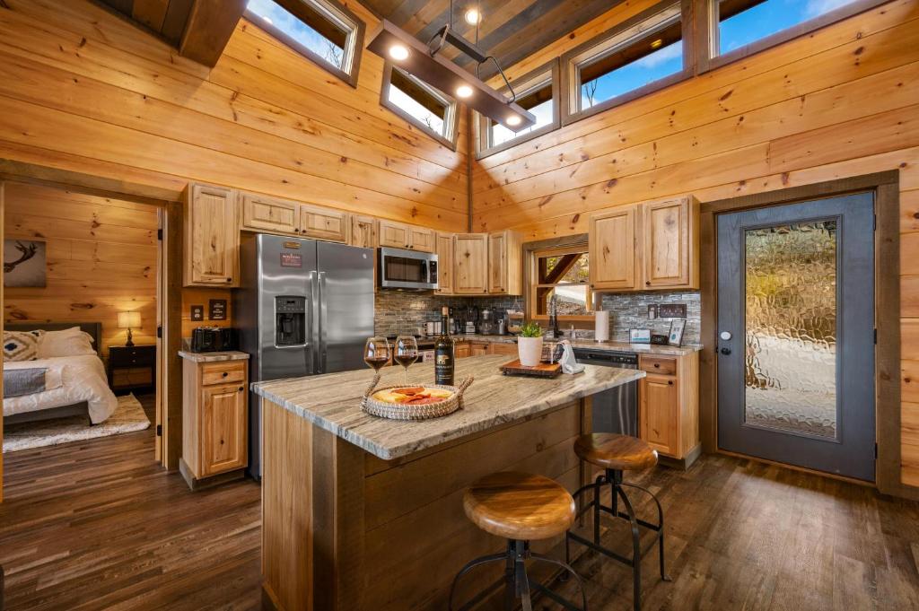 The kitchen island with stools and stainless appliances · © The Overlook