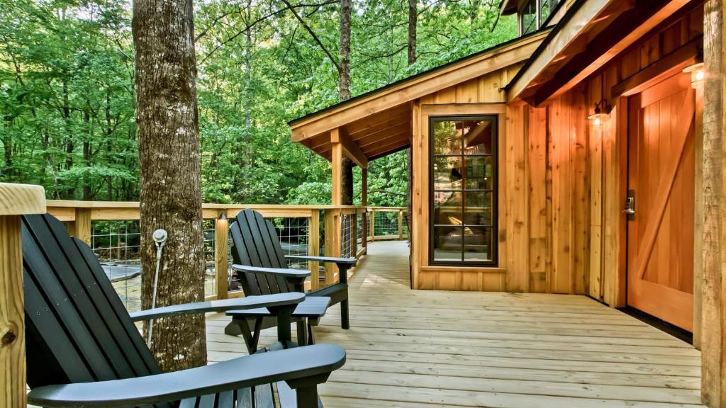 Adirondack chairs beside the trunk on the deck · © The Poplar at Treehouse Grove