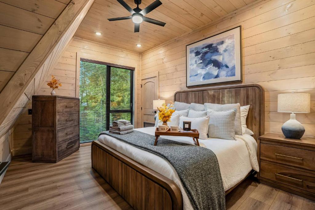 A bedroom under the sloping A-frame roofline · © The Sleek Covemont A-Frame