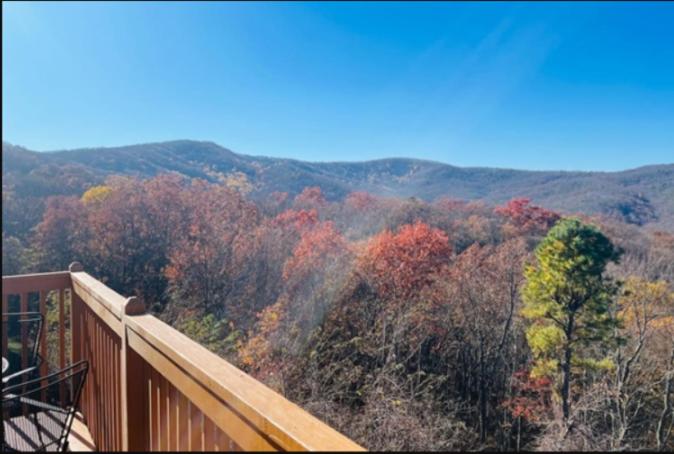 Autumn color on the slope below the deck railing · © Top of World