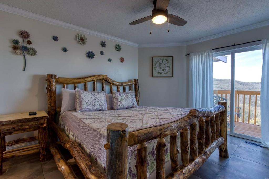A log-frame bed with a sliding door out to a balcony · © Top of World