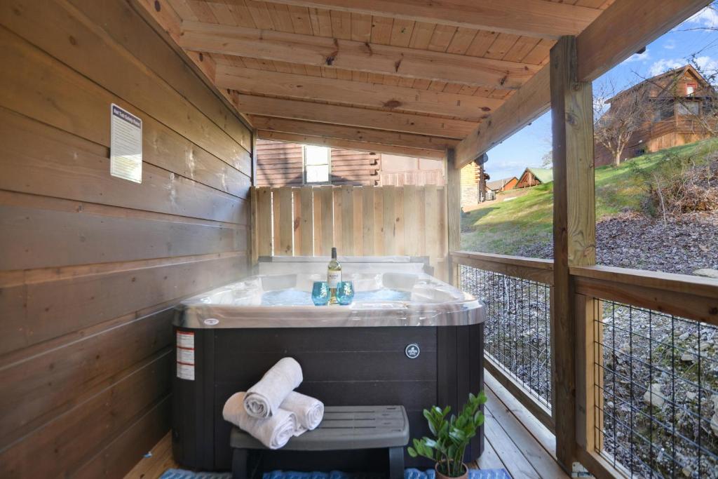 The private hot tub on the covered back deck · © Tsaliwood Cabin
