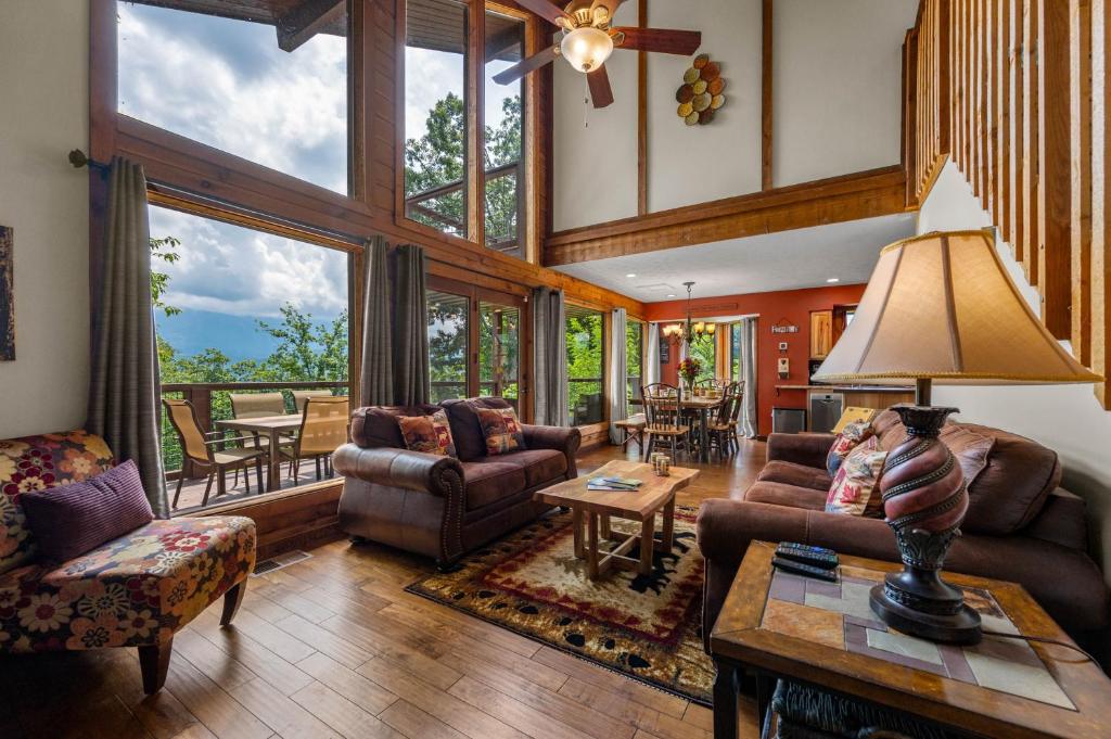 The great room's glass wall onto the deck and ridge · © Twinflower Summit