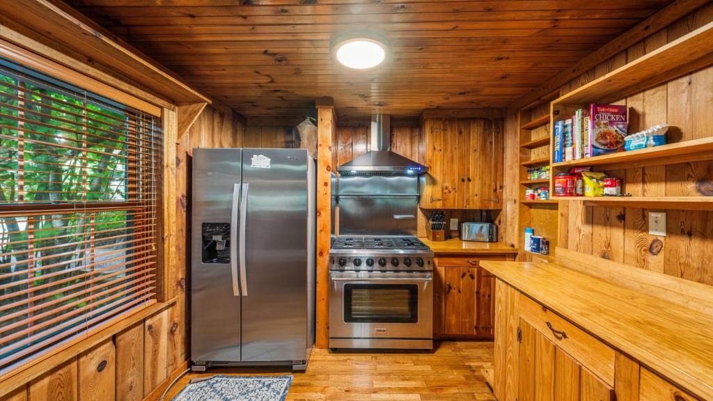 A pine-paneled kitchen with a gas range · © Whiskey Ridge Lodge